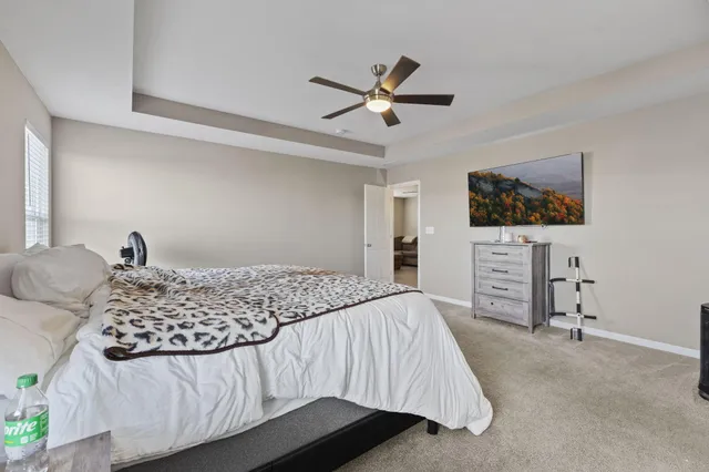 a en suite bathroom with a shower sink and mirror