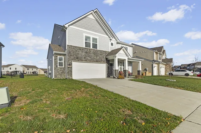 a front view of the house with a garden