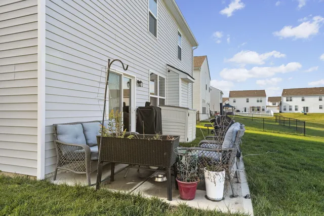 a backyard of a house with table and chairs
