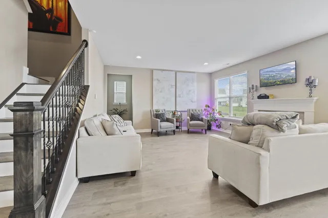 a living room with furniture and a book shelf