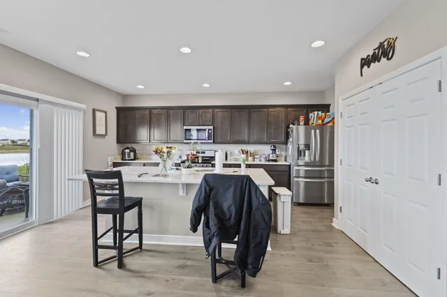 a kitchen with refrigerator and cabinets