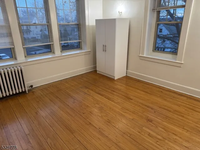 a view of room with wooden floor