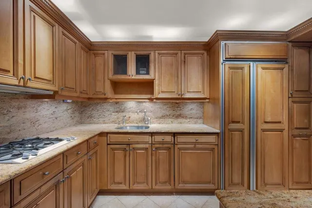 a kitchen with stainless steel appliances granite countertop cabinets and window