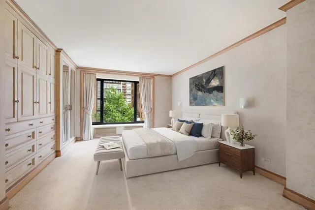 a bedroom with a bed potted plant on dresser and a window