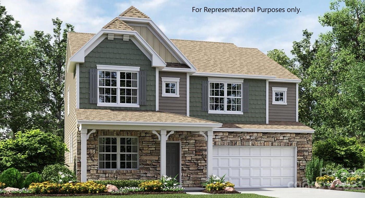 a front view of a house with plants