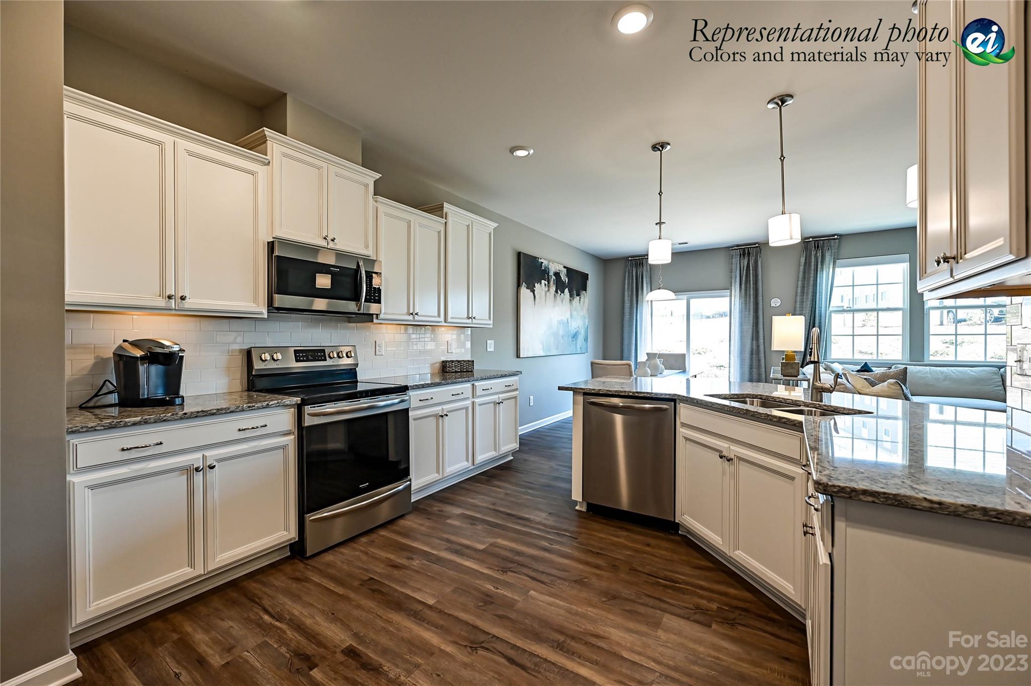5653 Soft Shell Drive, Unit 376 Lancaster, SC 29720 - Photo 11 of 30 a kitchen with kitchen island granite countertop a sink a counter top space stainless steel appliances and cabinets