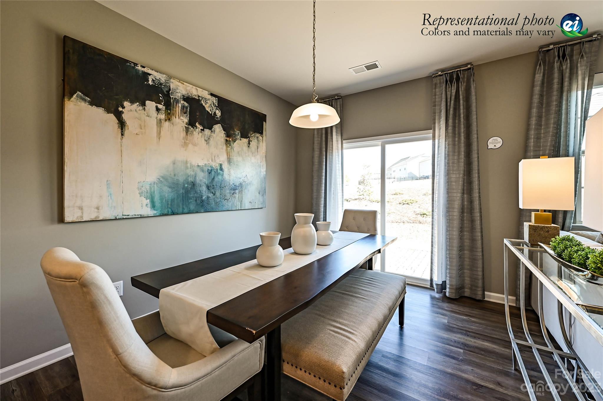 5653 Soft Shell Drive, Unit 376 Lancaster, SC 29720 - Photo 13 of 30 a dining room with wooden floor a chandelier a wooden table and chairs