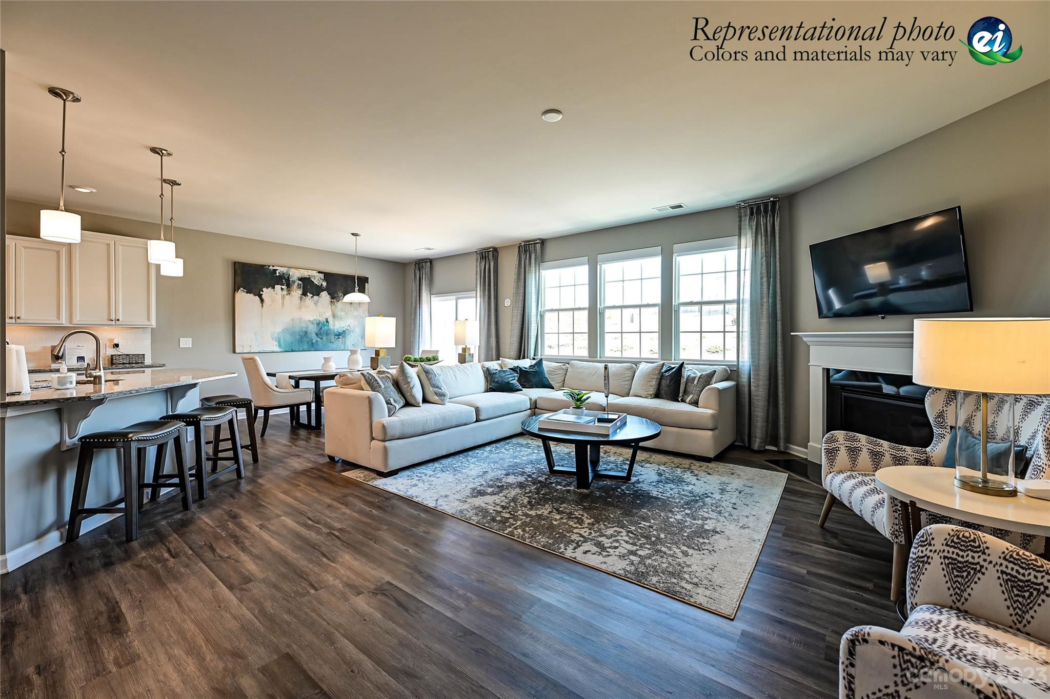 5653 Soft Shell Drive, Unit 376 Lancaster, SC 29720 - Photo 4 of 30 a living room with furniture a flat screen tv and kitchen view