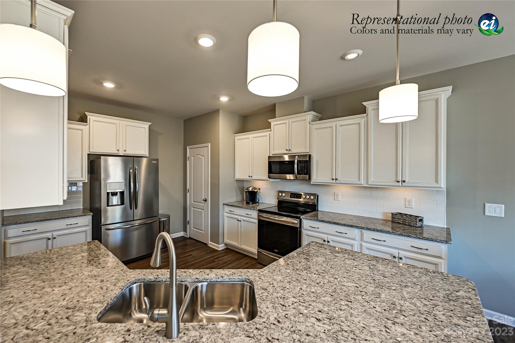 5653 Soft Shell Drive, Unit 376 Lancaster, SC 29720 - Photo 9 of 30 a kitchen with stainless steel appliances granite countertop a sink refrigerator and microwave