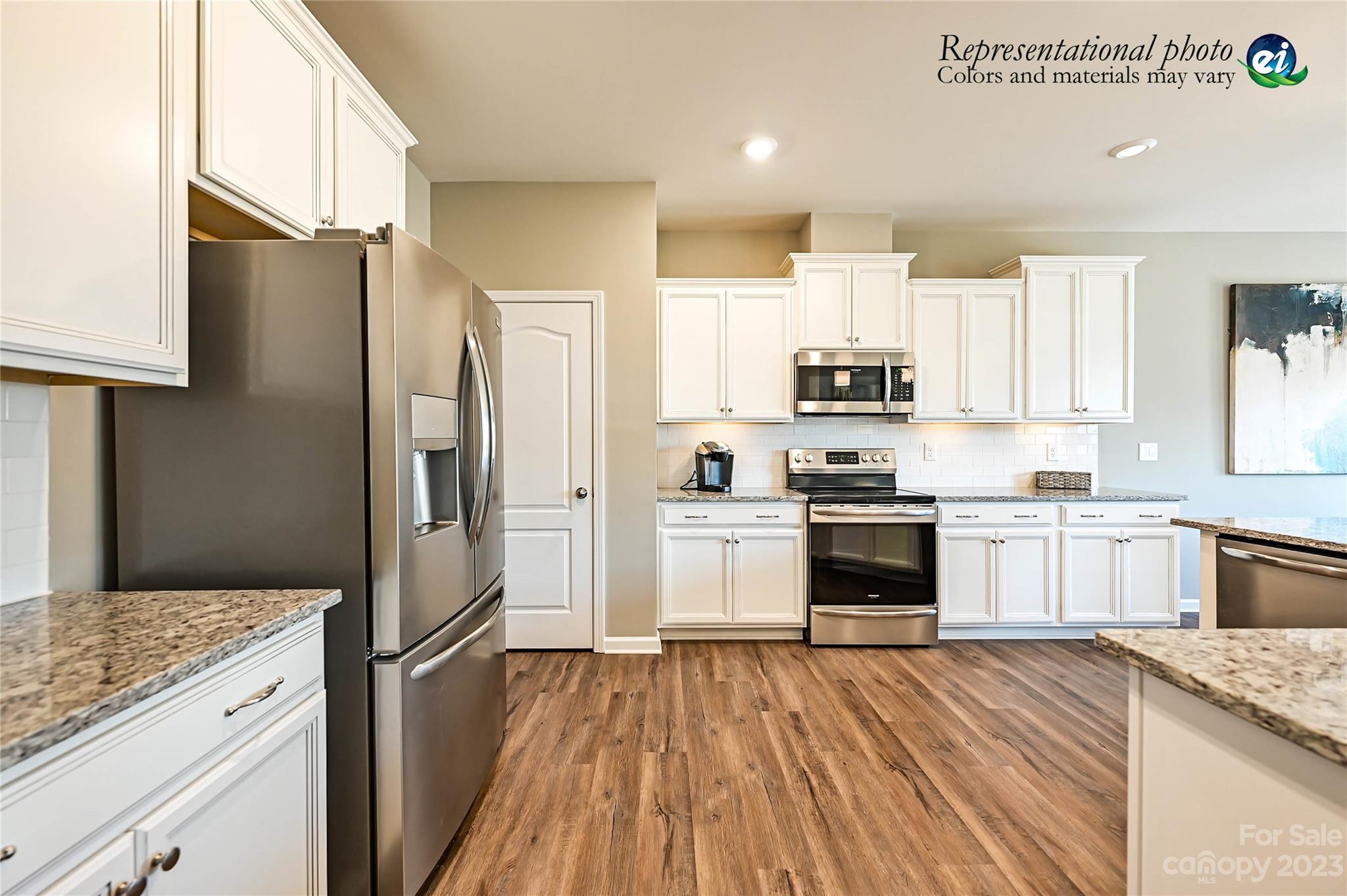 5653 Soft Shell Drive, Unit 376 Lancaster, SC 29720 - Photo 10 of 30 a kitchen with a refrigerator and a stove top oven