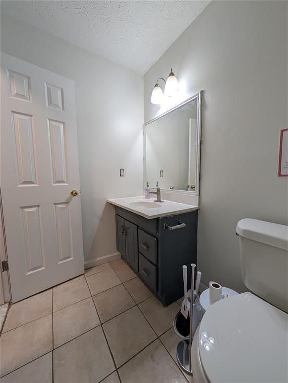 355 Shannon Way Lawrenceville, GA 30044 - Photo 14 of 42 a bathroom with a sink a toilet and mirror