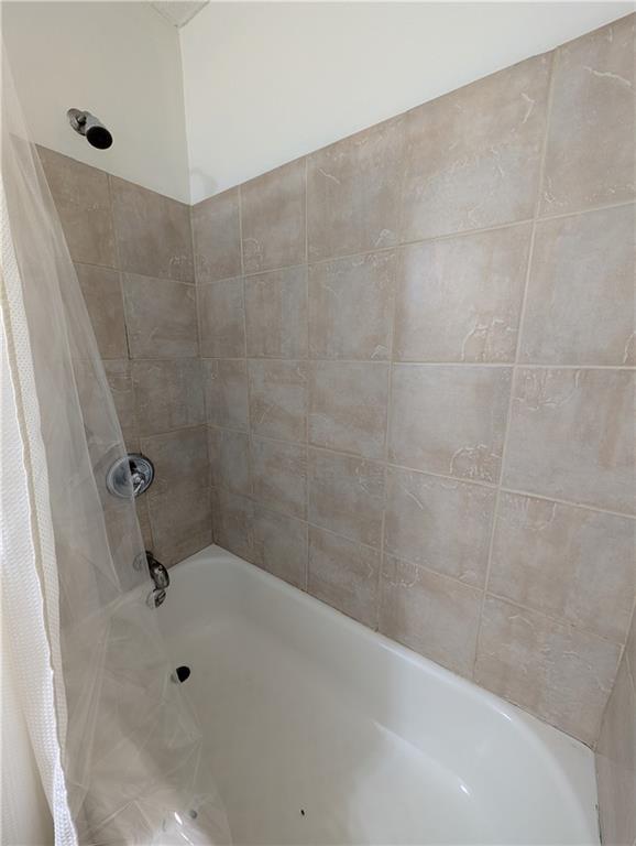 355 Shannon Way Lawrenceville, GA 30044 - Photo 15 of 42 a bathroom with a bathtub