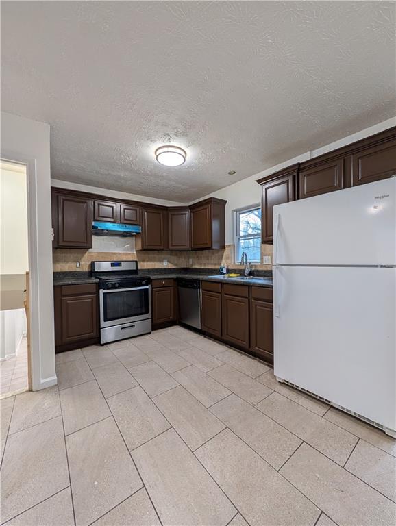 355 Shannon Way Lawrenceville, GA 30044 - Photo 29 of 42 a kitchen with granite countertop a refrigerator and a stove top oven