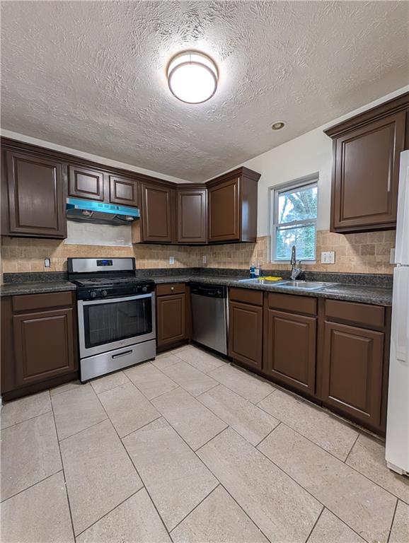 355 Shannon Way Lawrenceville, GA 30044 - Photo 30 of 42 a kitchen with stainless steel appliances granite countertop a stove sink and cabinets