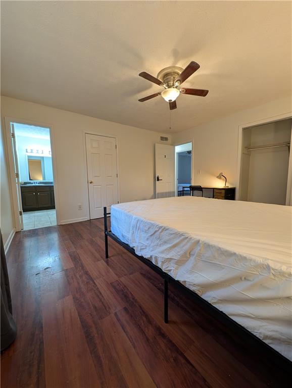 355 Shannon Way Lawrenceville, GA 30044 - Photo 4 of 42 a bedroom with a bed and wooden floor