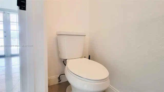a white toilet sitting next to a white sink