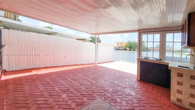 a big room with wooden floor and windows