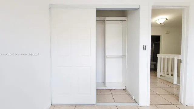 a view of walk in closet with white walls