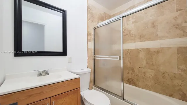 a bathroom with a shower and a toilet