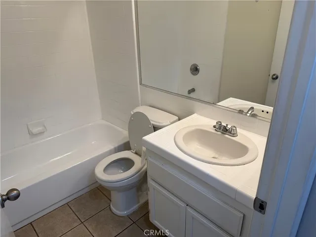 a bathroom with a toilet a sink and bathtub
