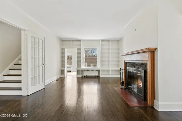 a balcony with wooden floor and trees in the back