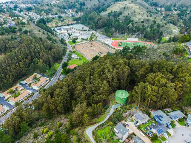 an aerial view of a houses with a yard