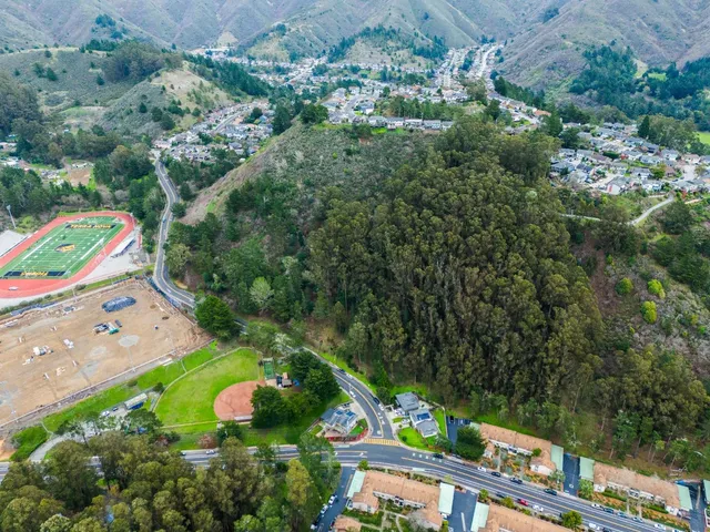 an aerial view of a house with a yard and lake view