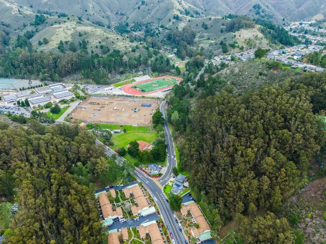an aerial view of residential houses with outdoor space