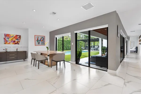 a view of a livingroom with furniture and large windows