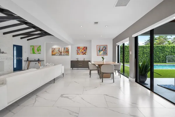 a living room with furniture and a floor to ceiling window
