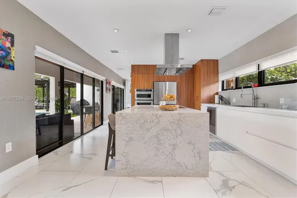 a large white kitchen with cabinets