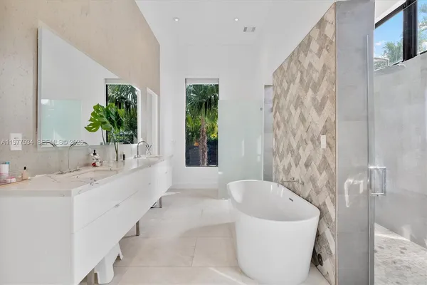 a bathroom with a bathtub sink and mirror