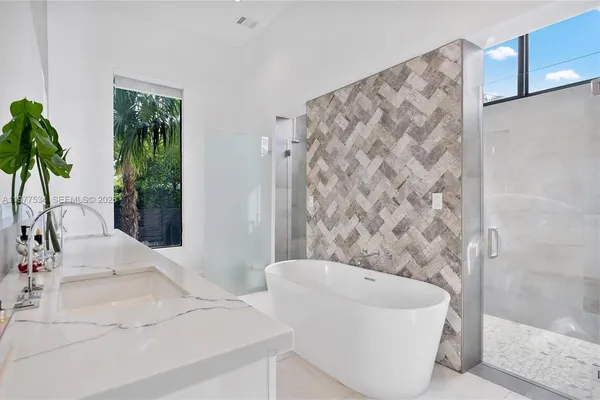 a bathroom with a bathtub and shower