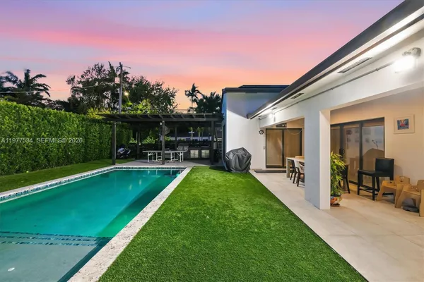 a view of a patio with dining table and chairs with a backyard