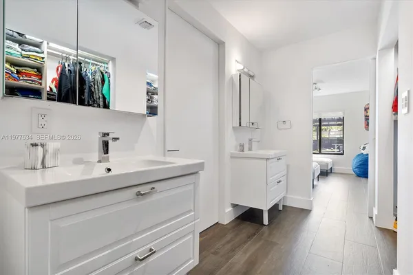 a spacious bathroom with a sink a mirror a vanity and a shower