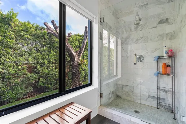 a bathroom with a glass shower door