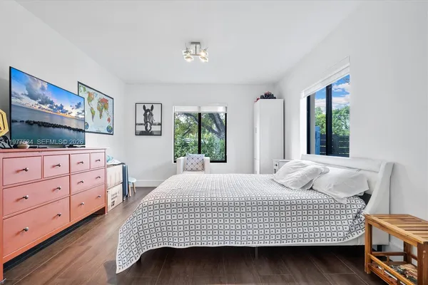 a bedroom with a bed and window