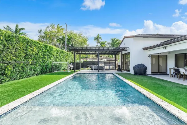 a view of a backyard with sitting area