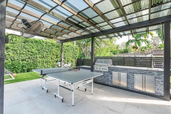 a view of a patio with table and chairs and potted plants