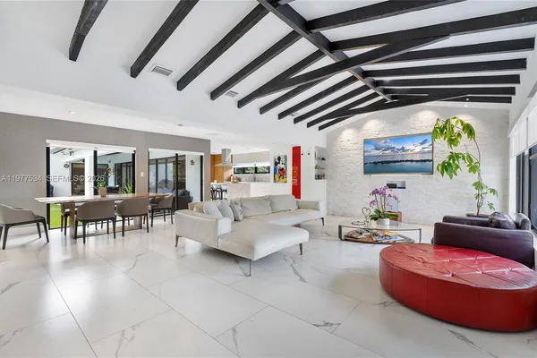 a living room with furniture and a flat screen tv