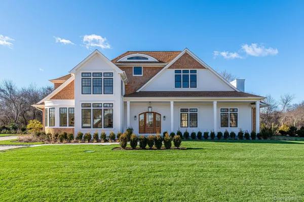 a front view of a house with a garden and yard