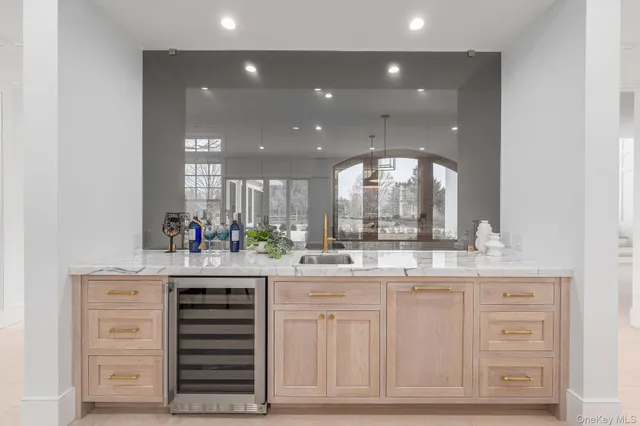 a living room with lots of furniture and kitchen view