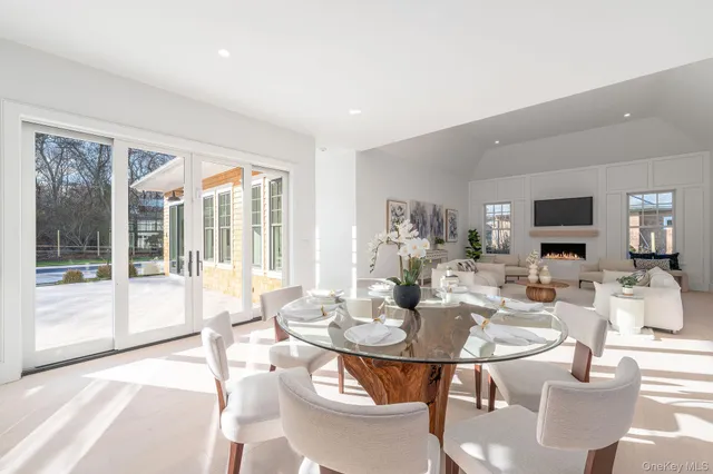 a living room with fireplace furniture and a large window