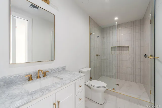 a spacious bathroom with a shower sink and mirror