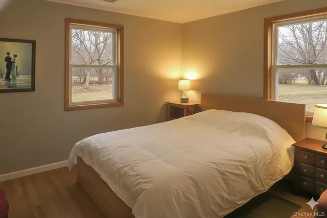a large bed sitting in a bedroom next to a window