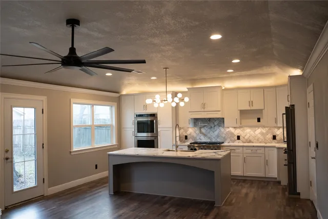 a kitchen with kitchen island white cabinets and white appliances