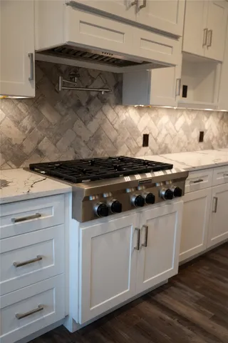 a white stove top oven sitting inside of a kitchen