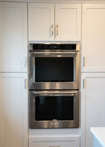 a stove top oven sitting inside of a kitchen