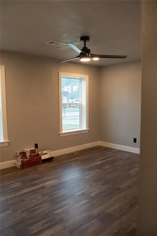 a view of room with wooden floor and windows