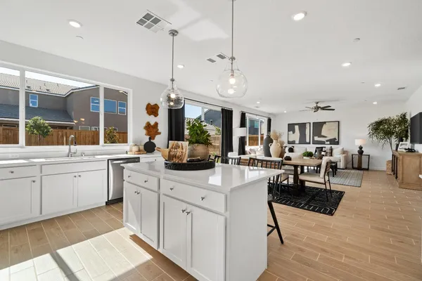 a kitchen with stainless steel appliances granite countertop a sink stove and cabinets
